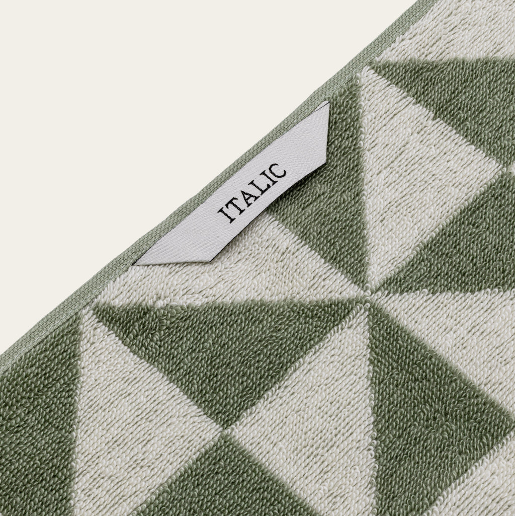 Italic Umbra Australian Cotton Bath Towel displayed on a bathroom hook, showcasing soft, plush texture and clean white color.