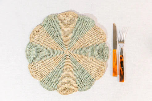 Blue pinwheel-shaped placemat made of raffia, perfect for tabletop decor, by Payton James.