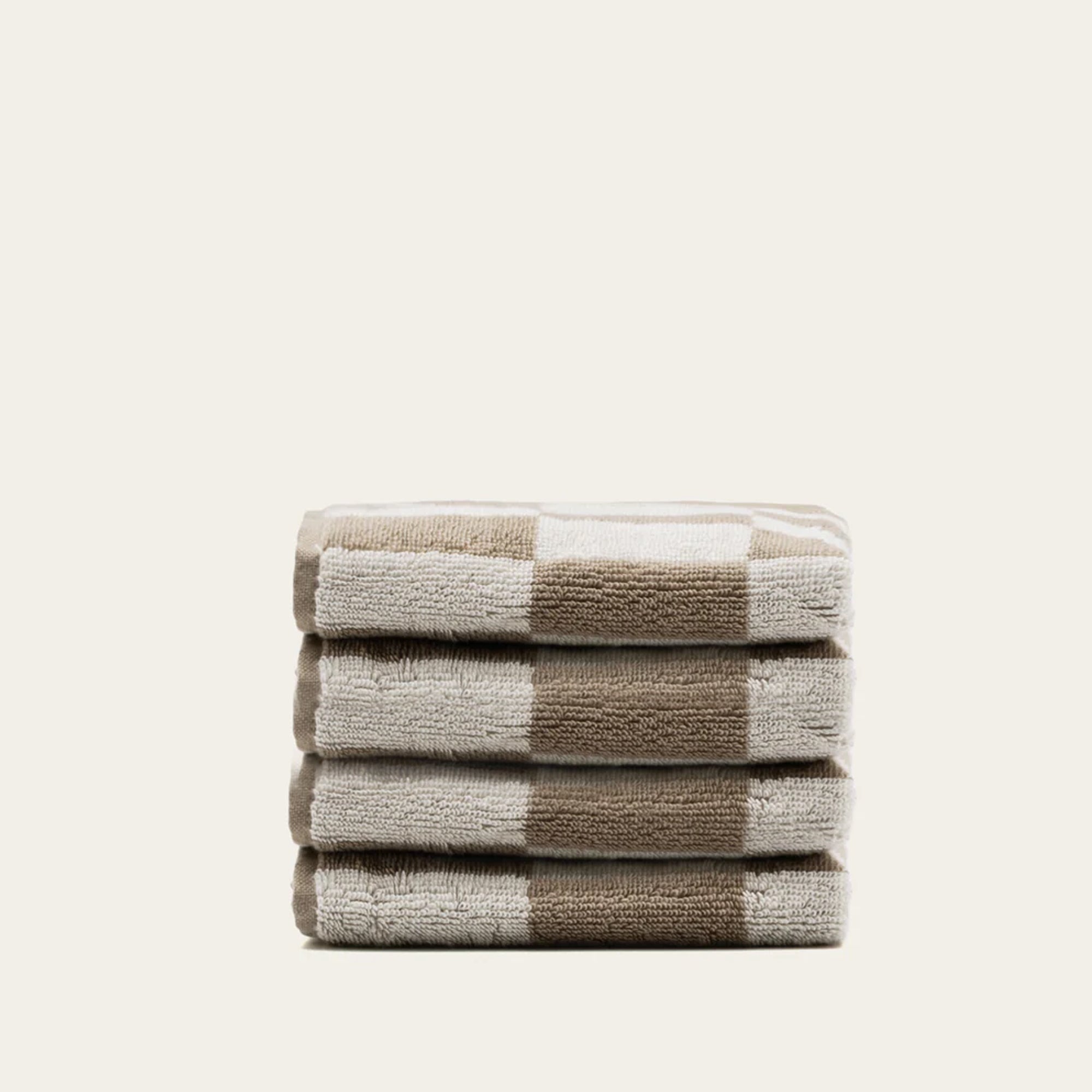 Set of four Pietra Australian Cotton Towels in tan, soft and absorbent, perfect for bathroom or kitchen use.