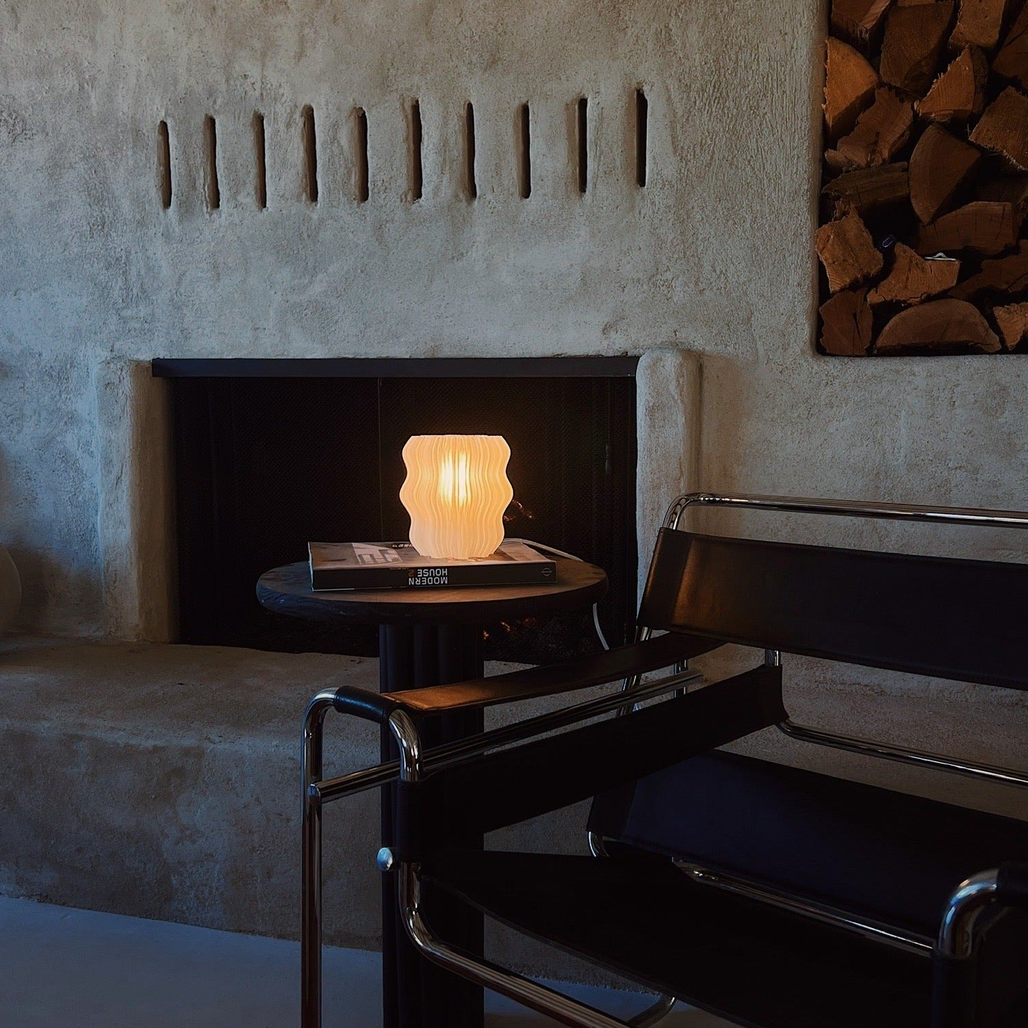 Mini Wavy Lamp by Wooj Design, featuring a sleek, modern wavy-shaped lamp with a soft glow on a minimalist surface.