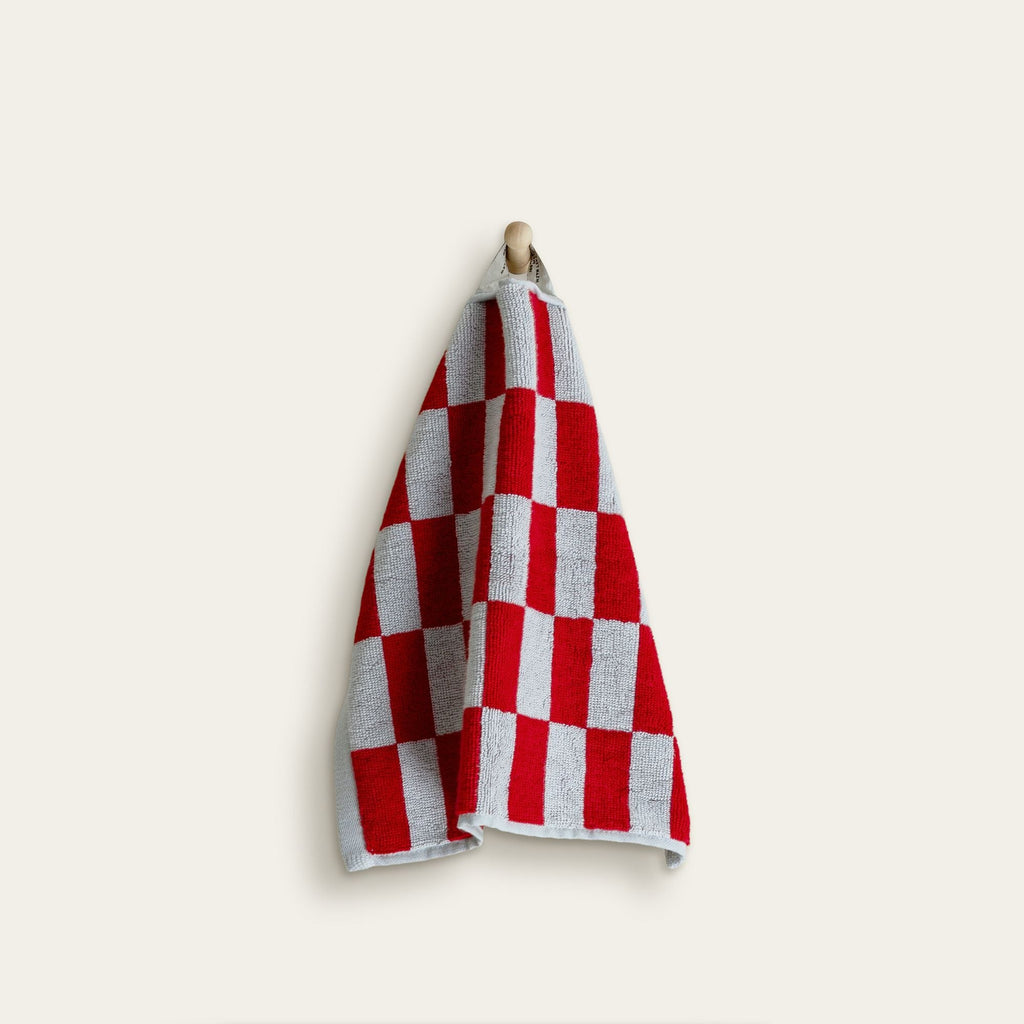 Soft Pietra Australian cotton towel from Italic with a textured, woven design, shown hanging on a wooden hook.