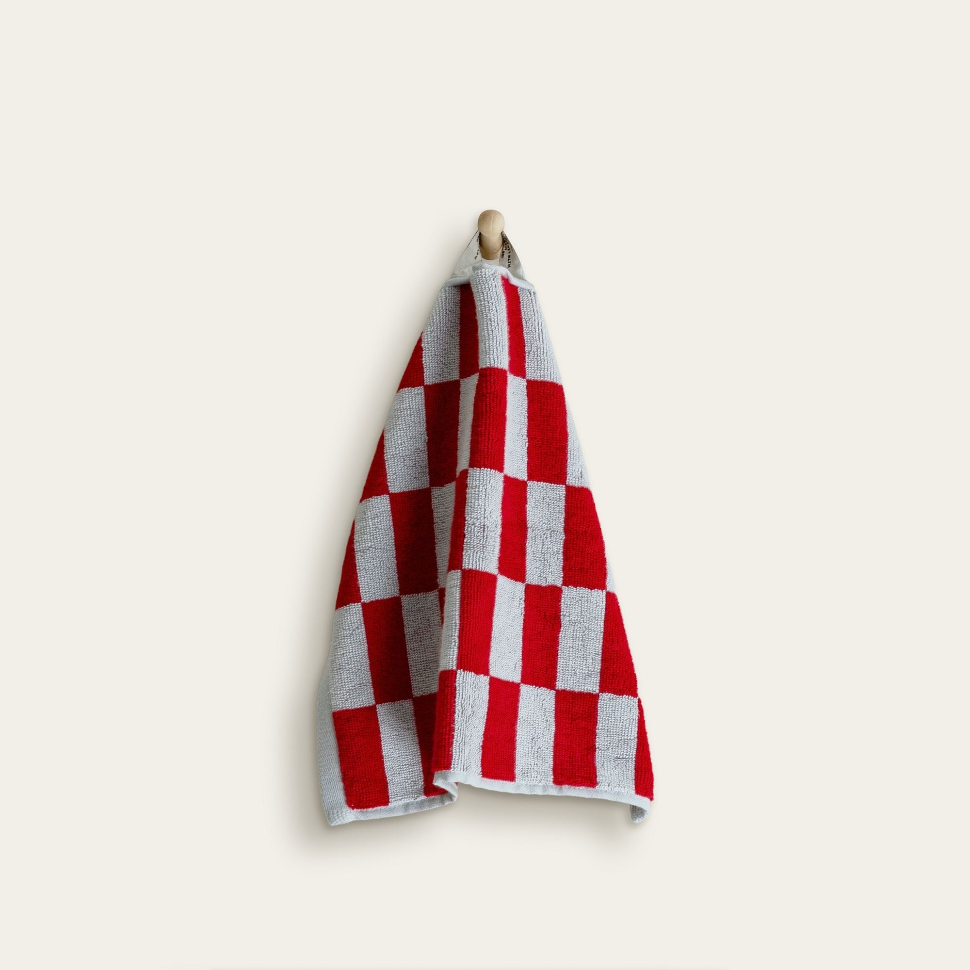 Soft Pietra Australian cotton towel from Italic with a textured, woven design, shown hanging on a wooden hook.