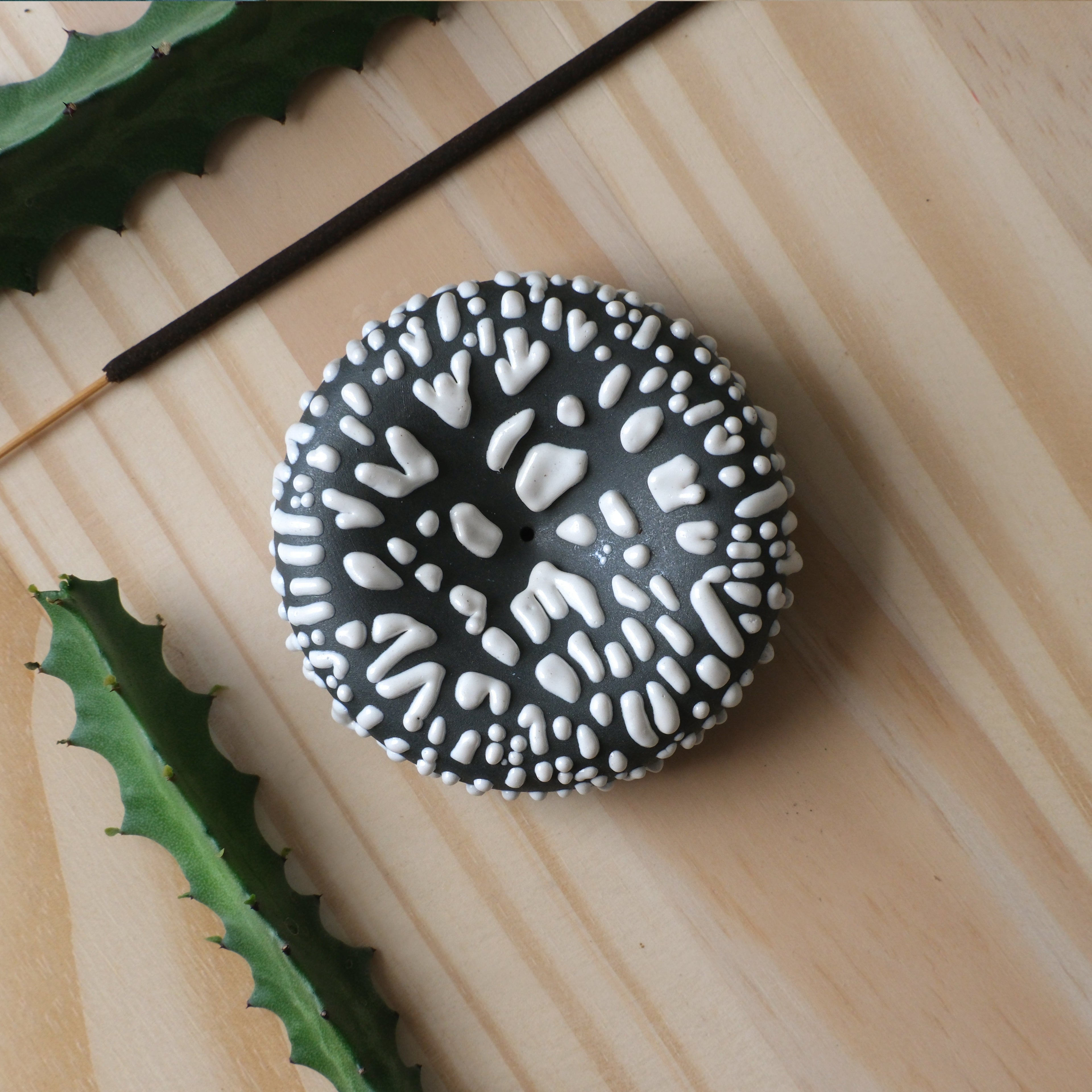 Black bird-shaped incense holder from Misewell's Eve Incense home accessories collection, featuring a decorative looped design.
