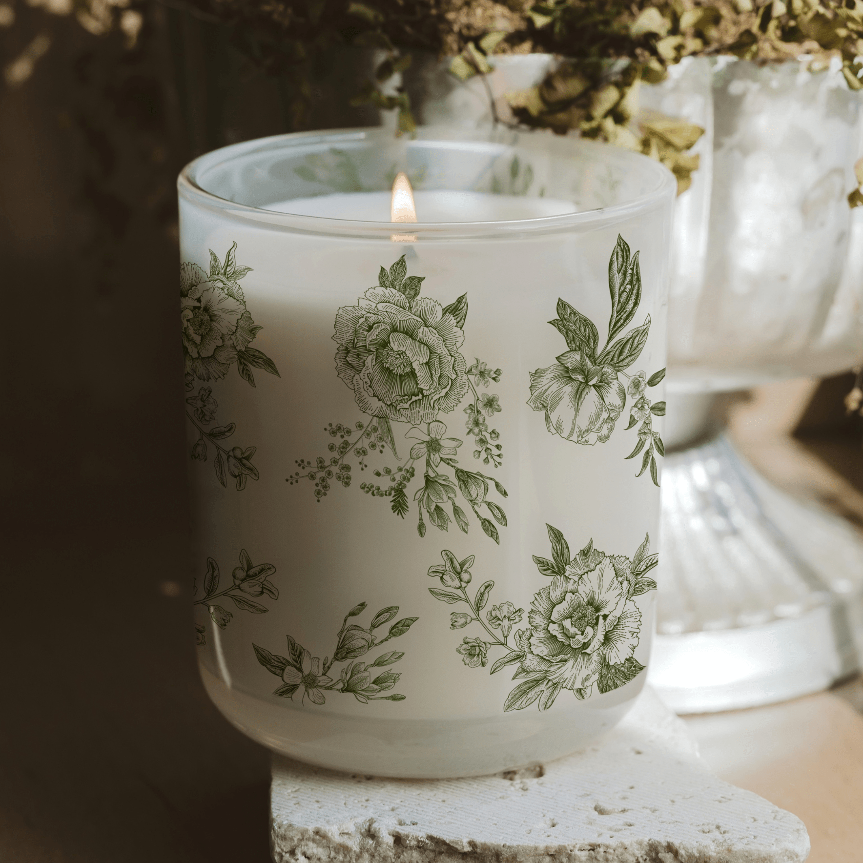 Green floral soy candle in a white translucent tinted glass jar, 12 oz with lavender and sage scent from Sweet Water Decor.