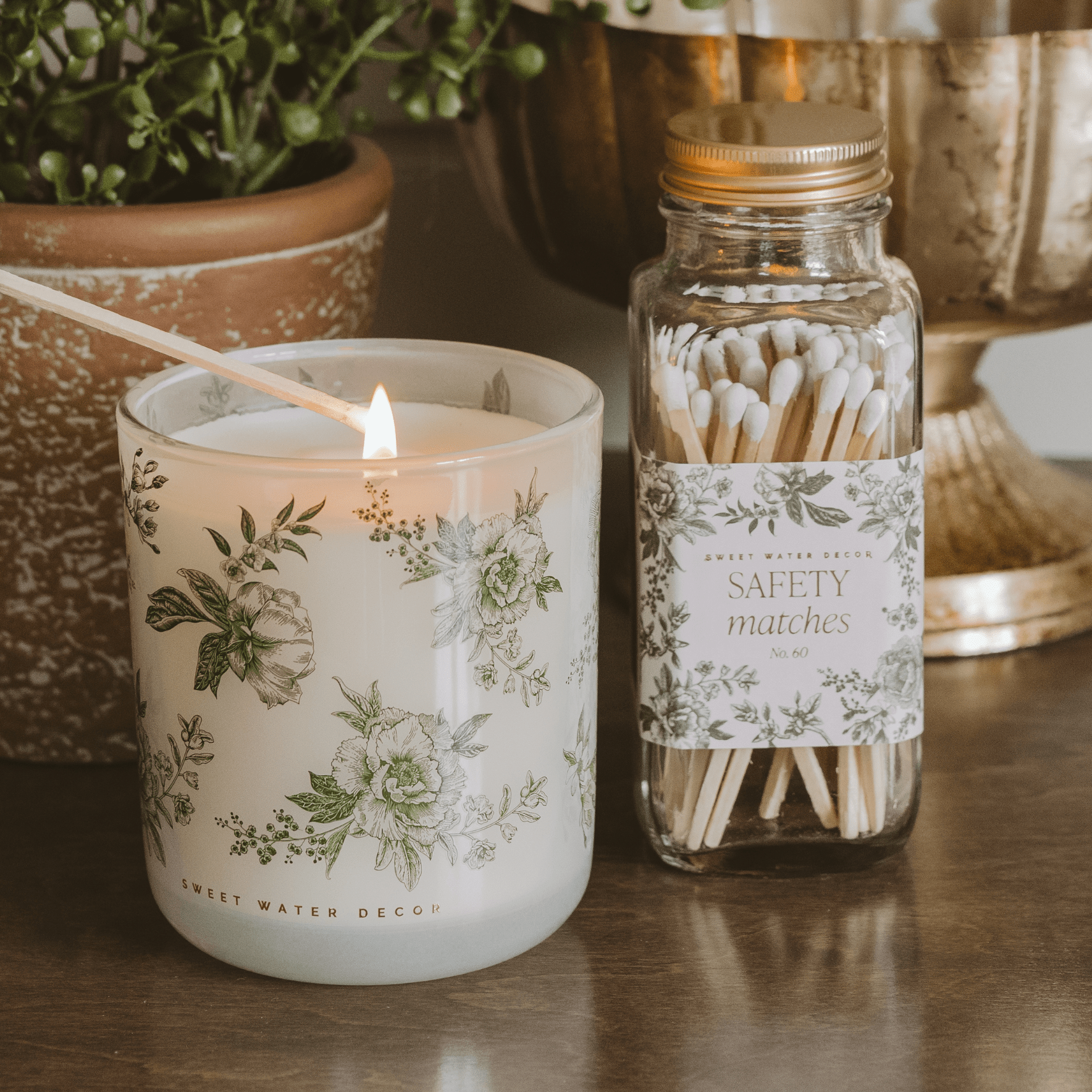 Green floral soy candle in a white tinted glass jar with lavender and sage pattern, 12 oz, by Sweet Water Decor.