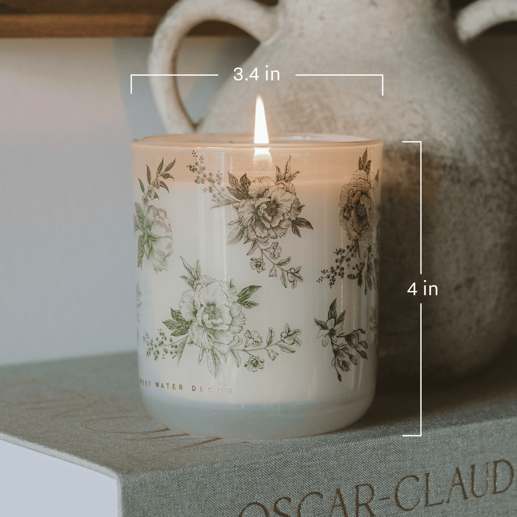 Green floral soy candle in a white translucent glass jar by Sweet Water Decor, lavender and sage scent, 12 oz.