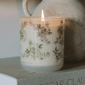 Green floral soy candle in a white tinted glass jar, 12 oz, with lavender and sage scent from Sweet Water Decor.