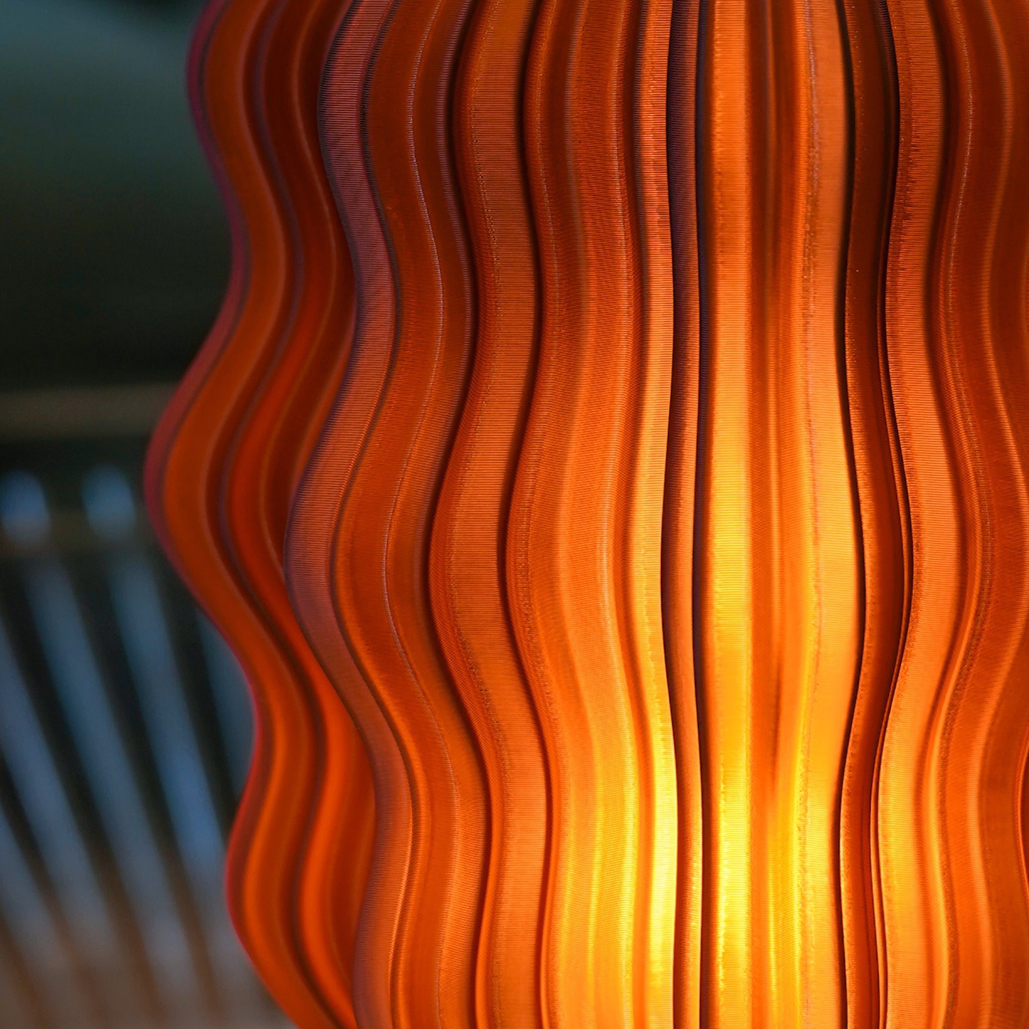 Close-up of Wooj Design Mini Wavy Lamp in amber with a cordless, wavy design, showcasing its textured surface and warm glow.