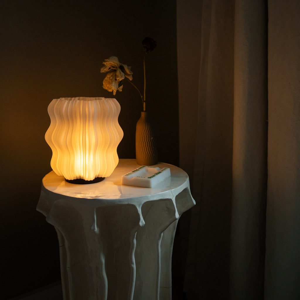 Wooj Design cordless mini wavy lamp illuminating a modern living space with warm, ambient light.