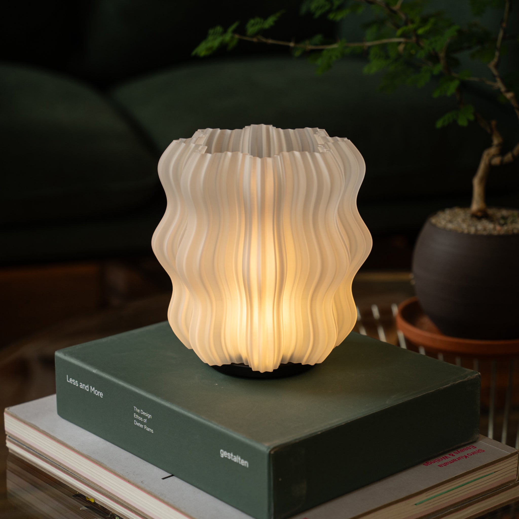 Wooj Design cordless mini wavy lamp emitting warm light, designed for modern living spaces and ambient lighting.