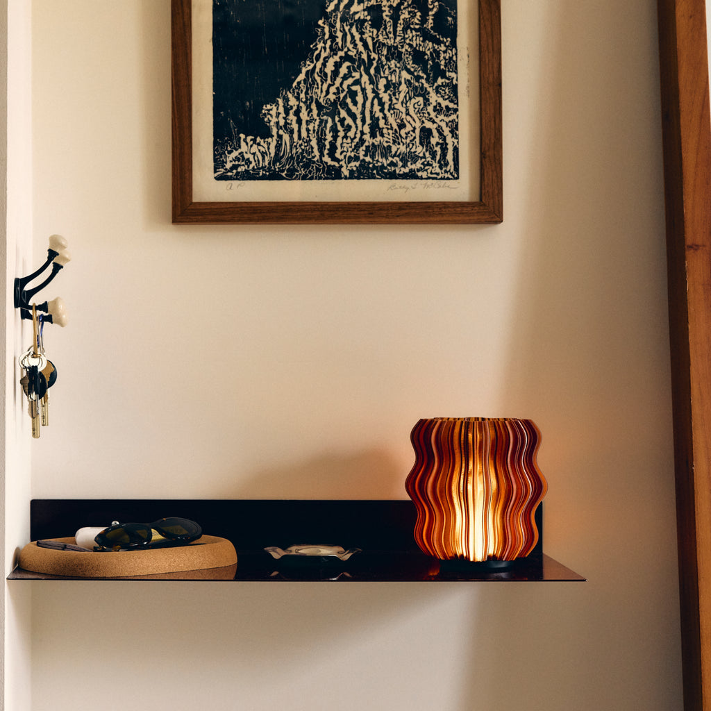 Wooj Design cordless mini wavy lamp glowing with warm amber light, showcasing its compact, stylish design for modern home decor.