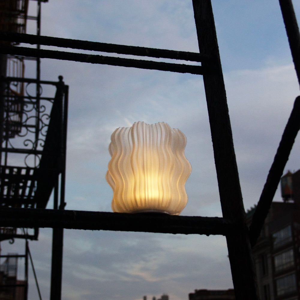 Wooj Design cordless mini wavy lamp emitting soft warm light, ideal for modern home decor and ambient lighting.