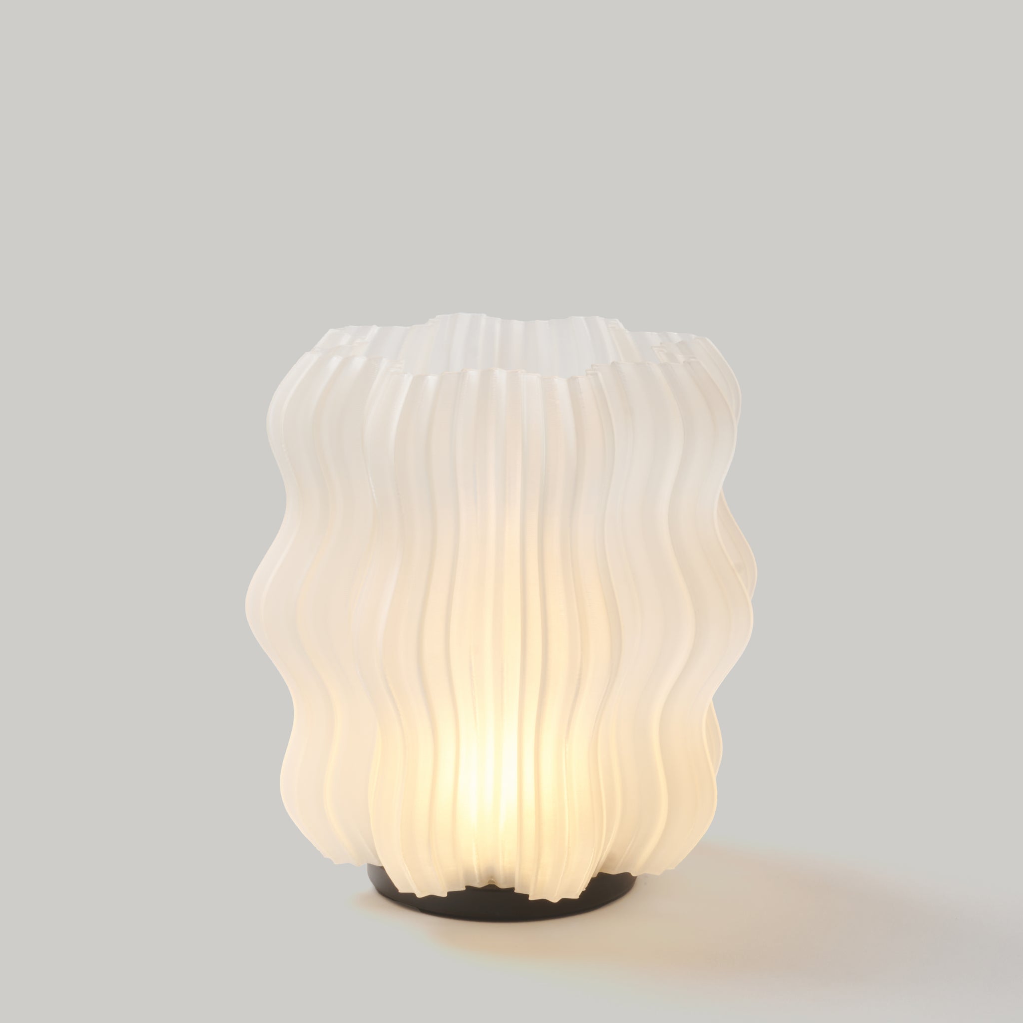 Wooj Design cordless mini wavy lamp with a sleek, natural-colored design, showcasing its modern, portable lighting style.