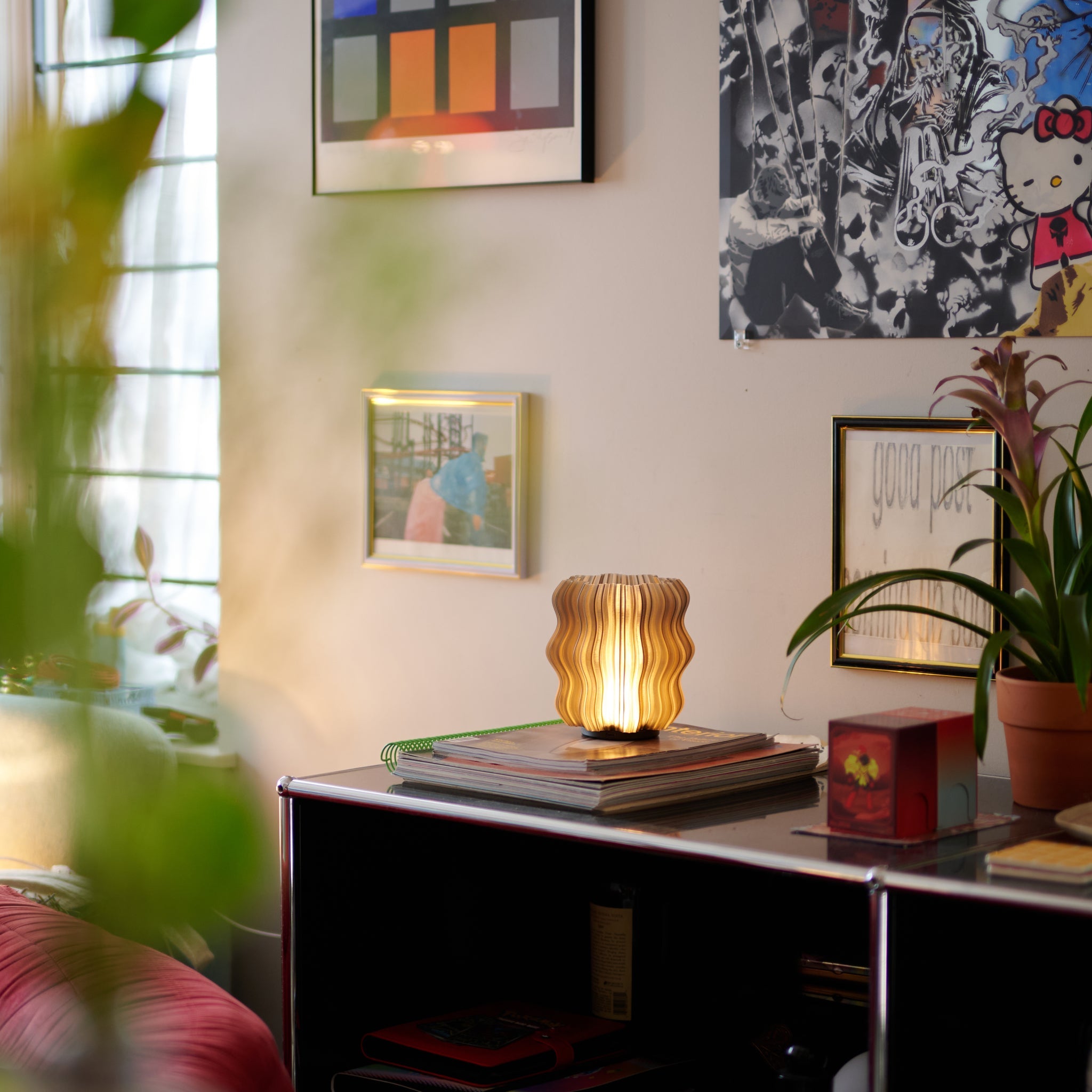 Wooj Design cordless mini wavy lamp emitting smoky light, placed on a modern side table in a cozy living space.