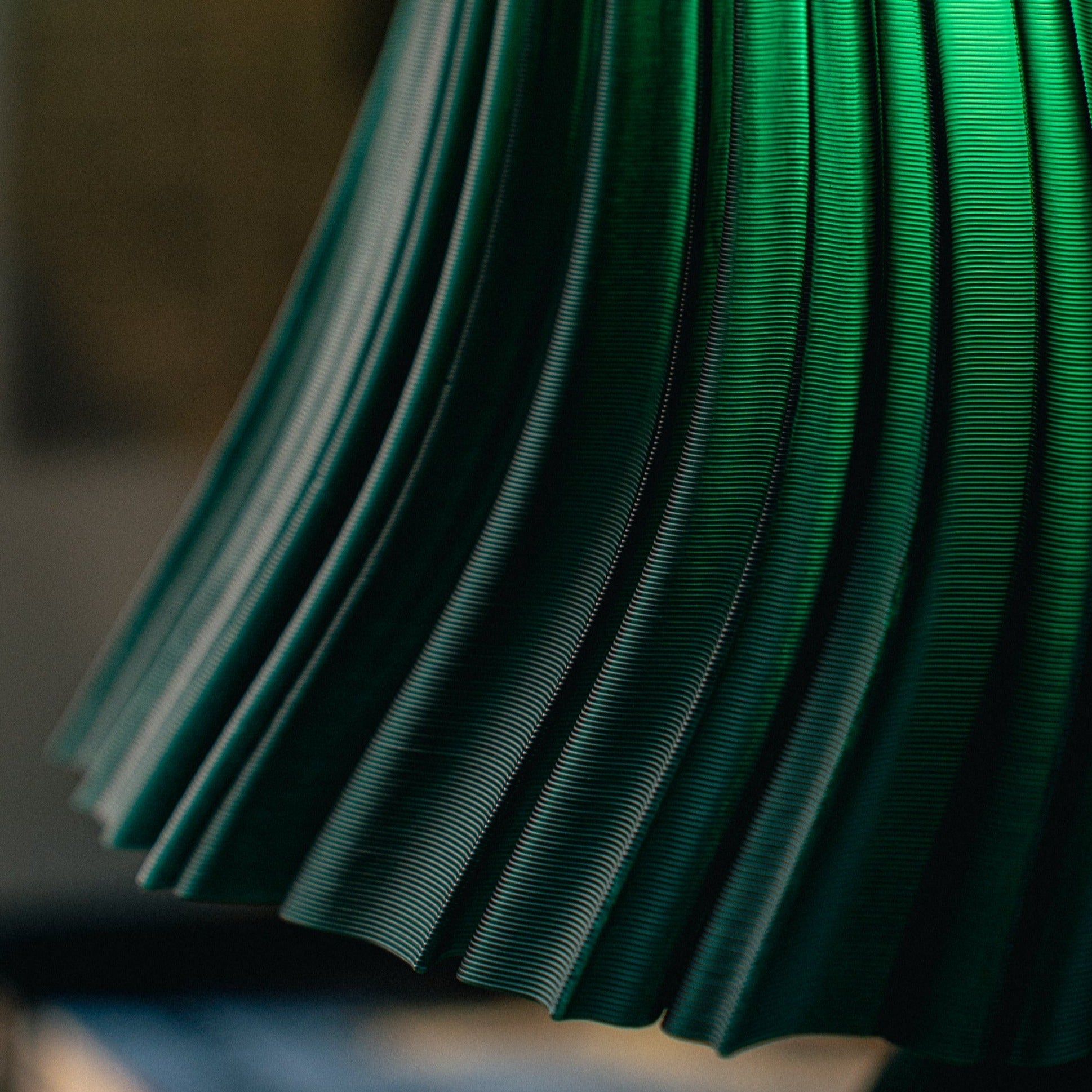 Wooj Design pleat lamp with a modern, textured fabric shade on a sleek base, providing stylish ambient lighting.