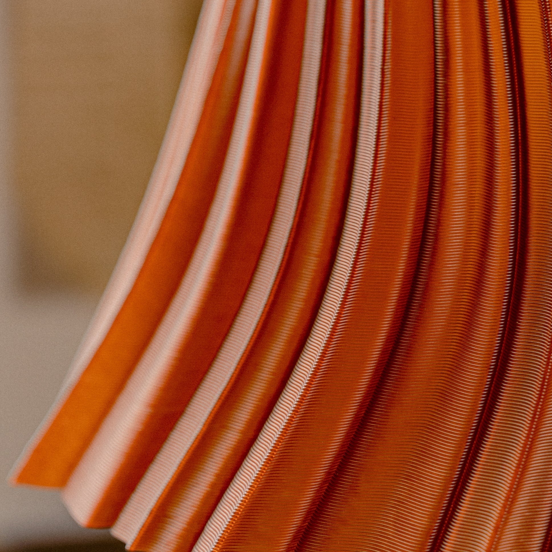Wooj Design pleat lamp with a fabric shade and sleek base, showcasing elegant lighting design and soft illumination.
