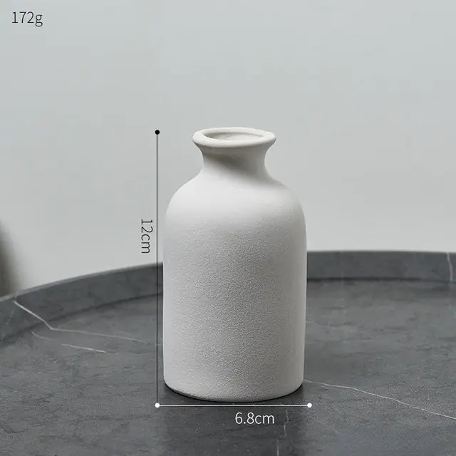 Simple Nordic style ceramic vase with a smooth white finish, ideal for modern home decor.