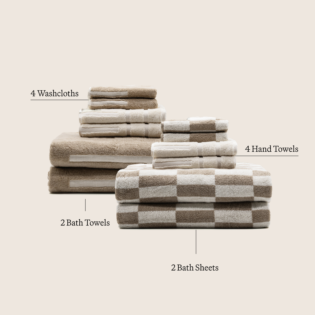 Family bundle of six Pietra Australian cotton towels by Italic, showing soft, plush white towels with textured weave.