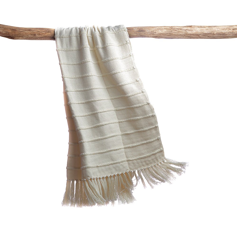 Ivory striped wool throw blanket from Homelosophy, cozy natural throw with multi-colored stripes for added warmth and style.