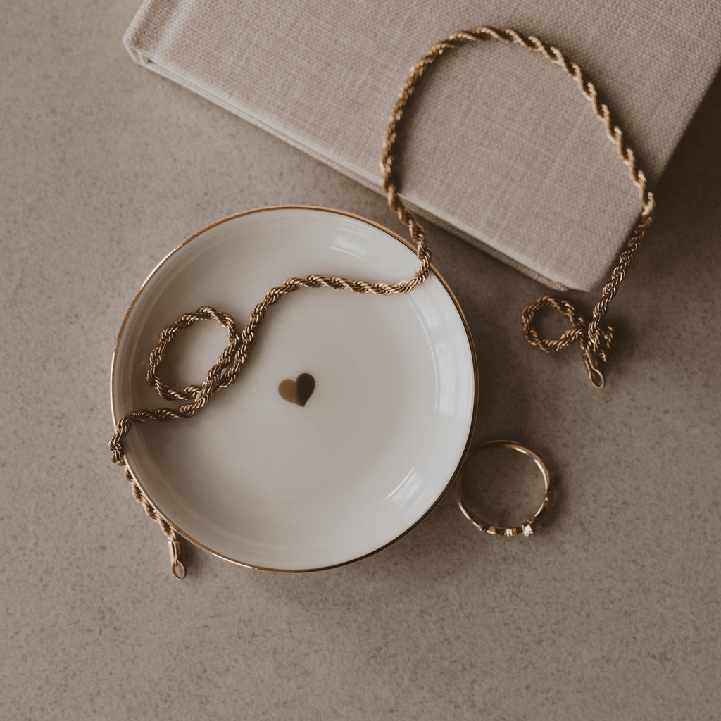Small gold heart-shaped jewelry dish from Sweet Water Decor, perfect for storing rings and trinkets.