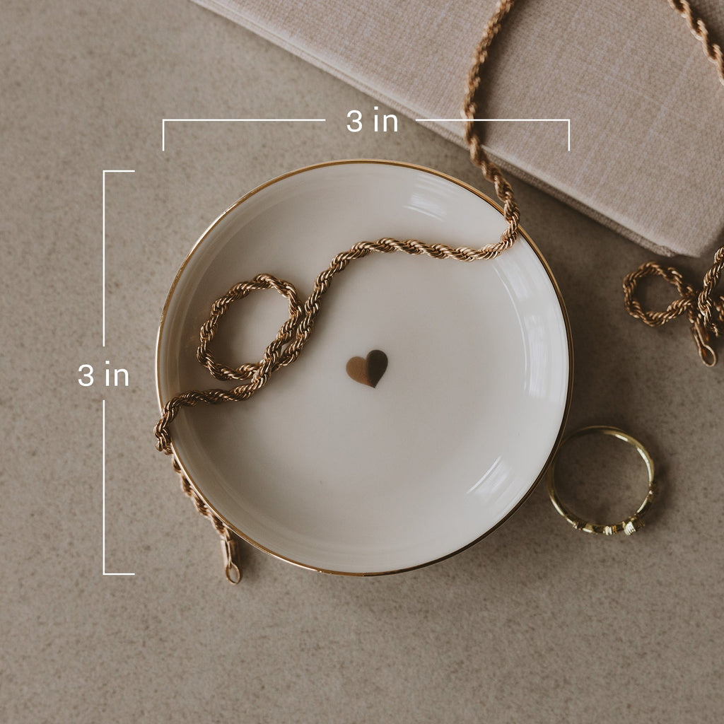 Gold heart-shaped jewelry dish from Sweet Water Decor, featuring a smooth, decorative jewelry holder for rings and small accessories.