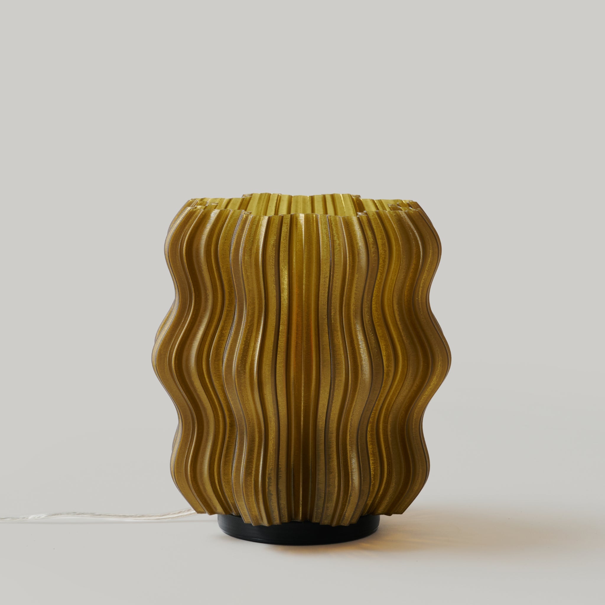 Mini wavy lamp by Wooj Design with a sleek black finish and wavy shape, perfect for modern home decor.