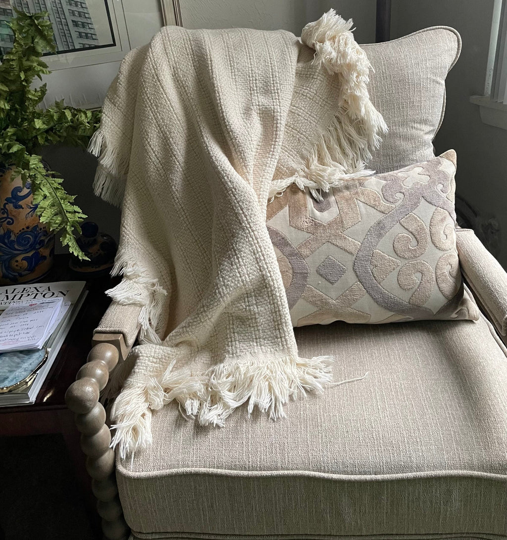 Carolina Cottons 100% cotton throw blanket in natural color draped over a chair, 52" x 65" size, cozy and soft home accessory.
