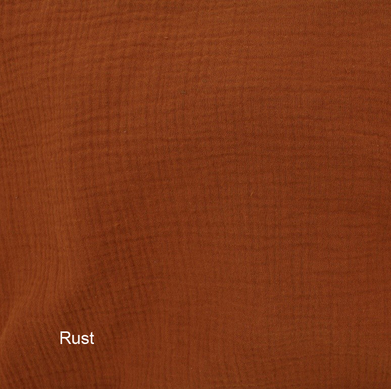 Wendy Anne Snuggle Me infant lounger slip cover in organic cotton double gauze, rust color, showing soft, breathable fabric.