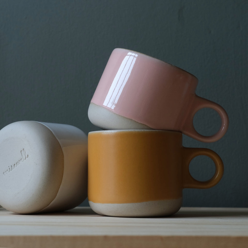 Pink and gold dipped Scotty tumbler mug by Misewell with a glossy finish and sleek design, perfect for beverages.