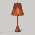 Wooj Design Pleat Lamp with a sleek, amber-colored pleated lampshade illuminating a modern interior space.