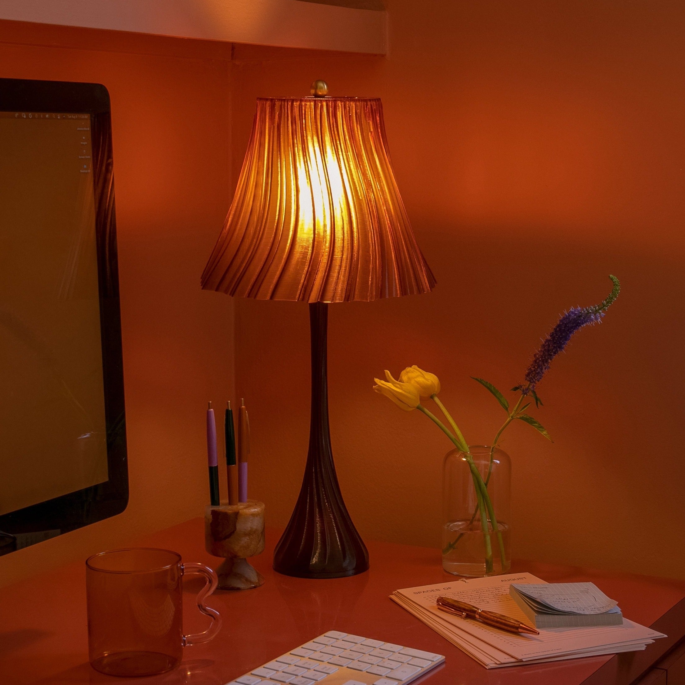 Wooj Design pleat lamp with a modern, pleated fabric shade and sleek base, showcasing elegant lighting design.