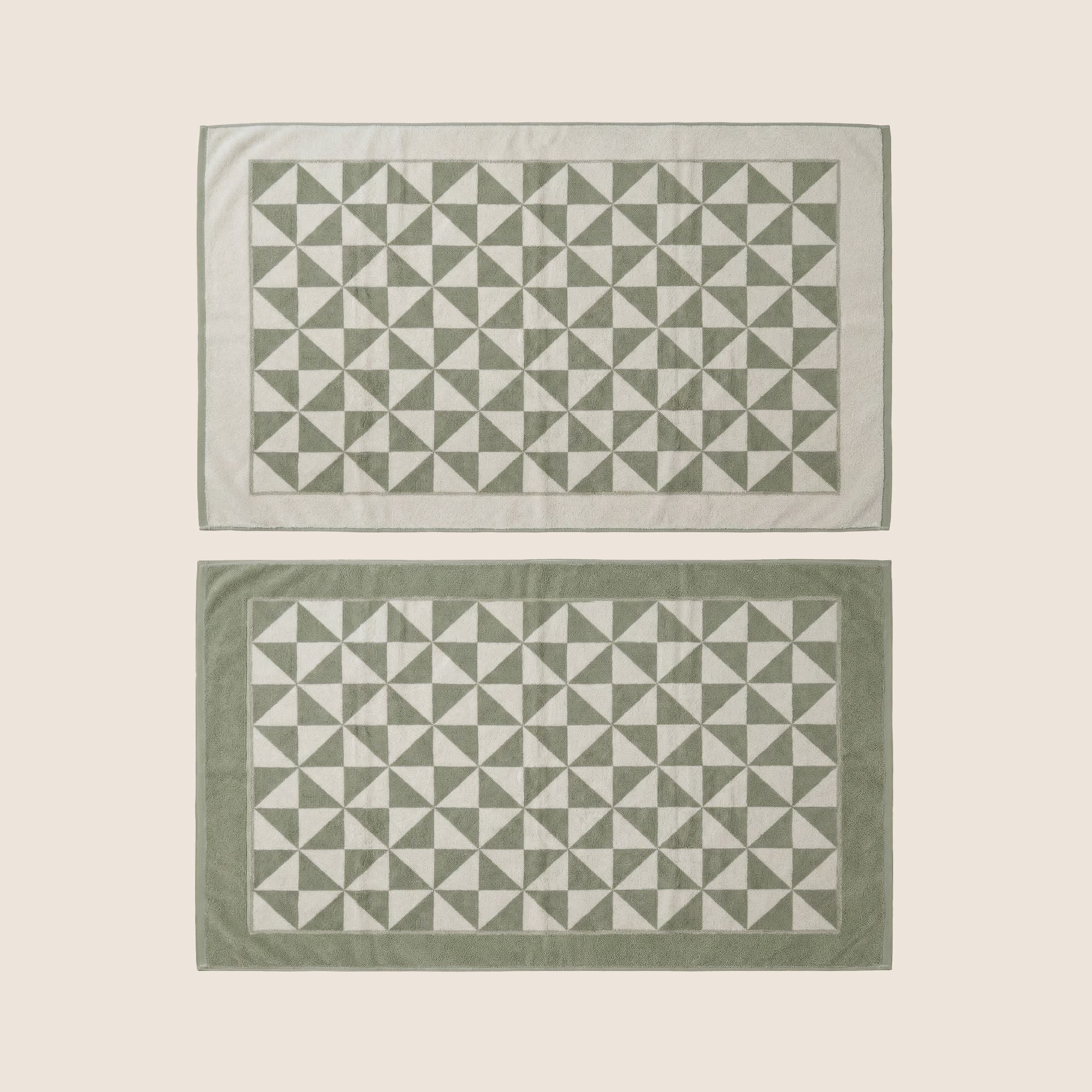 Umbra Australian cotton bath towels in a flatlay display, featuring soft, plush texture ideal for home bath use.