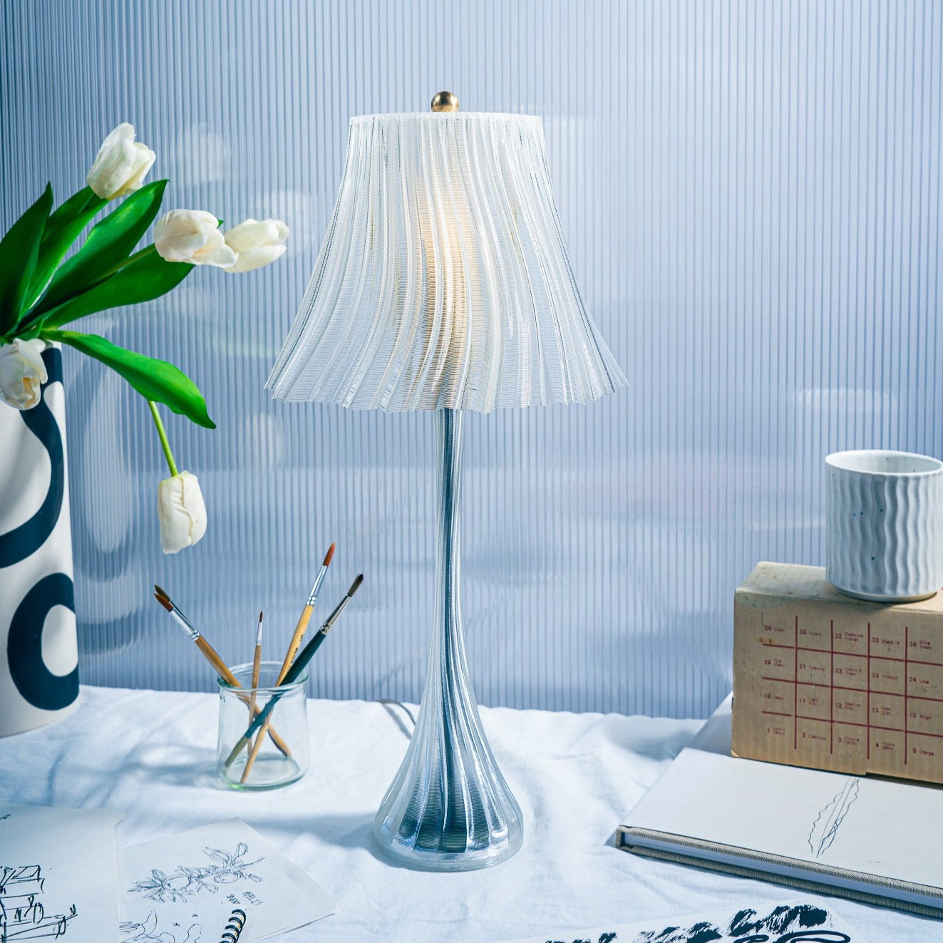 Wooj Design Pleat Lamp with a sleek, modern pleated fabric shade and minimalist base, ideal for contemporary interior lighting.