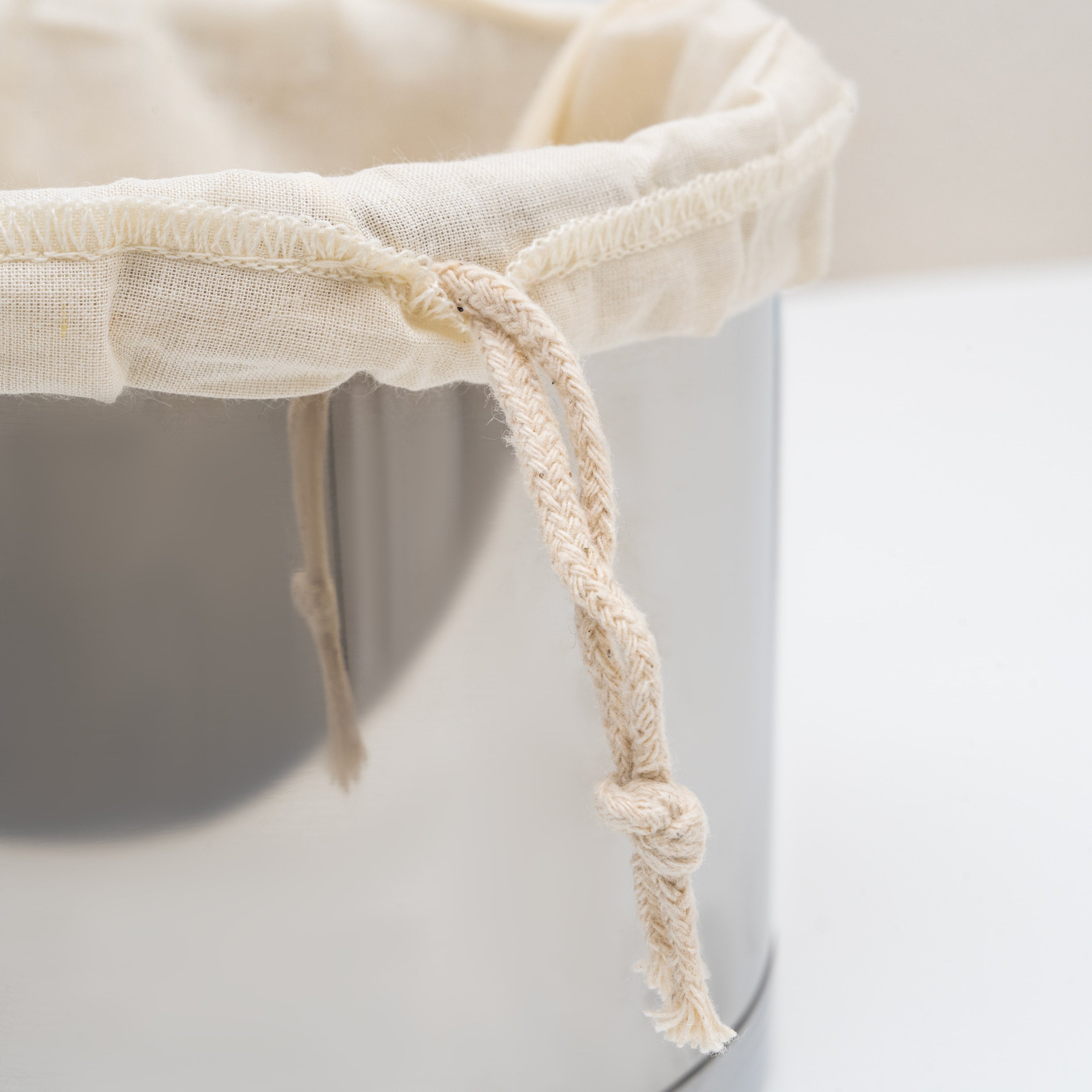 Organic cotton nut milk bags used as strainers or colanders for homemade nut milk and plant-based beverage preparation.