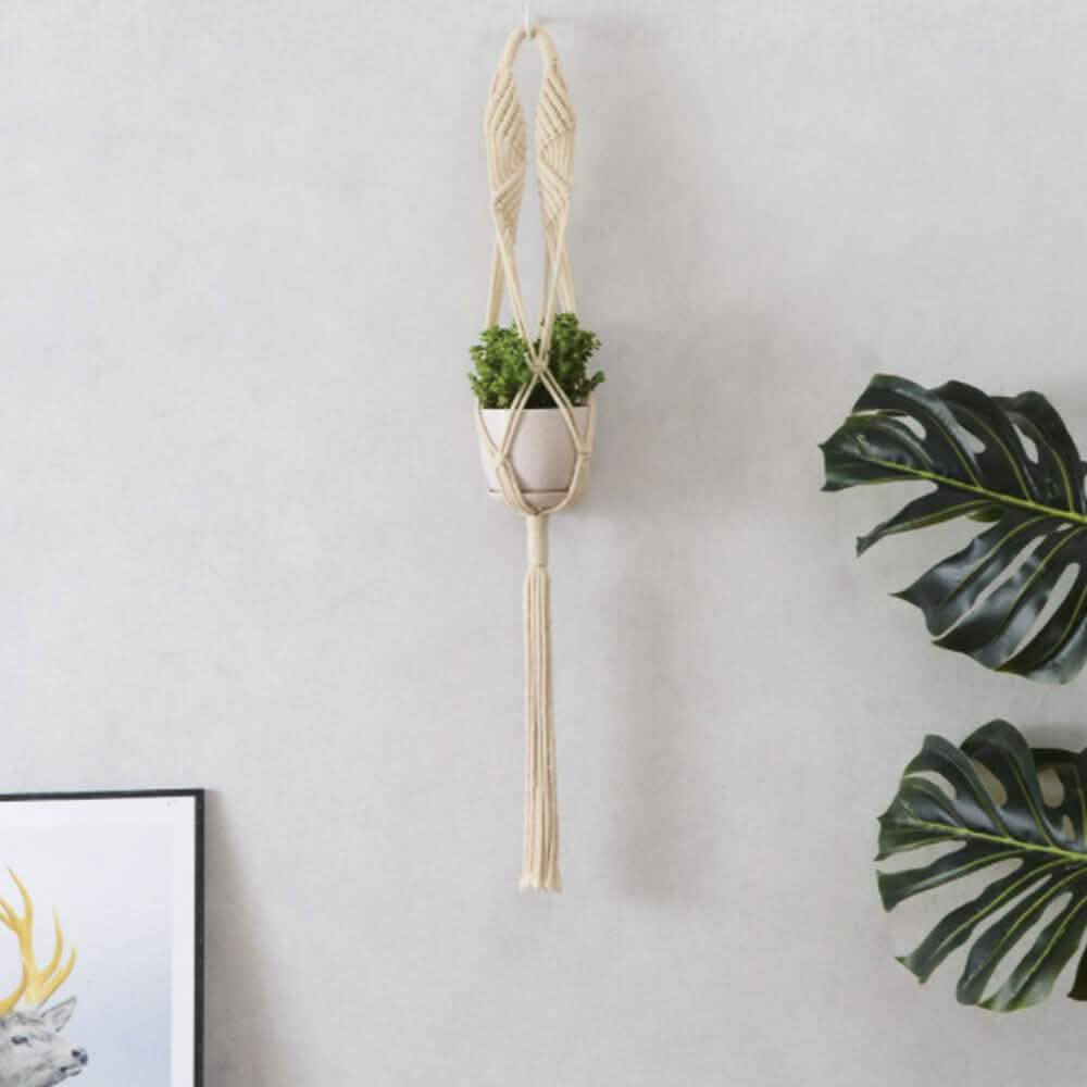 Hand-woven macrame tapestry plant hanger holder for indoor decor, featuring intricate knots and natural cotton material.
