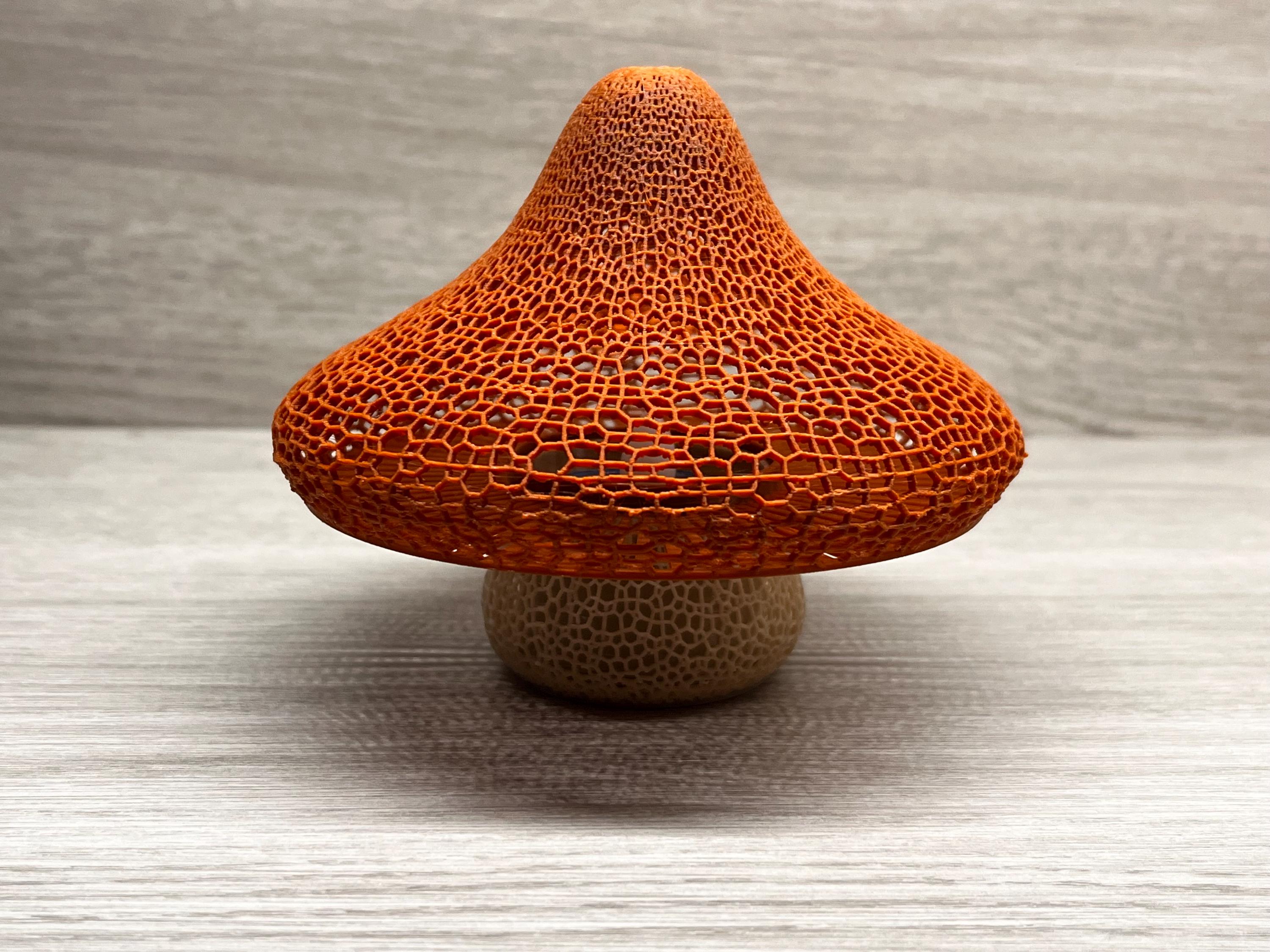 3D Concepts Mushroom Lattice Solar Tea Light glowing with warm light, decorative outdoor solar-powered garden lantern.