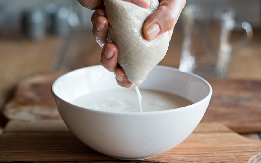 Organic cotton nut milk bags used as strainers, suitable for making nut milk and filtering liquids in the kitchen.