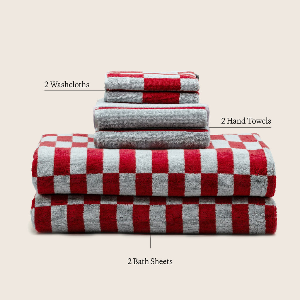 Set of 15 luxe Pietra Australian cotton towels by Italic, showcasing plush, absorbent white bath towels with textured detailing.