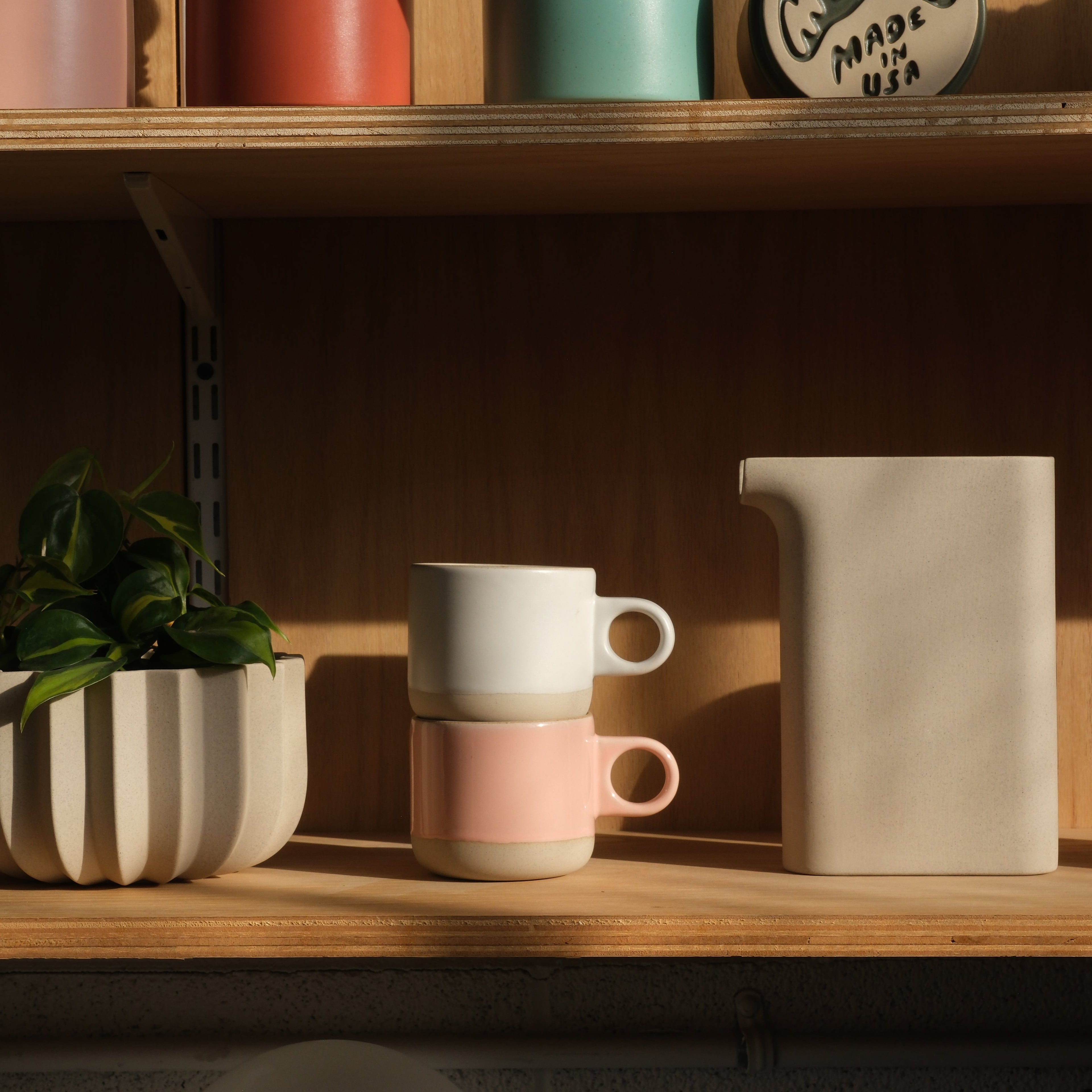 Misewell Scotty Mug tumbler with dipped design, shown on a shelf with other ceramic mugs.