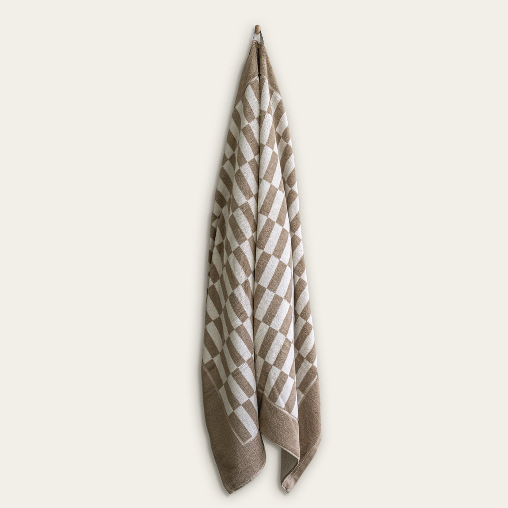 Italic Pietra Australian Cotton bath sheet displaying plush, soft white towels with a textured weave pattern, ideal for luxurious drying.