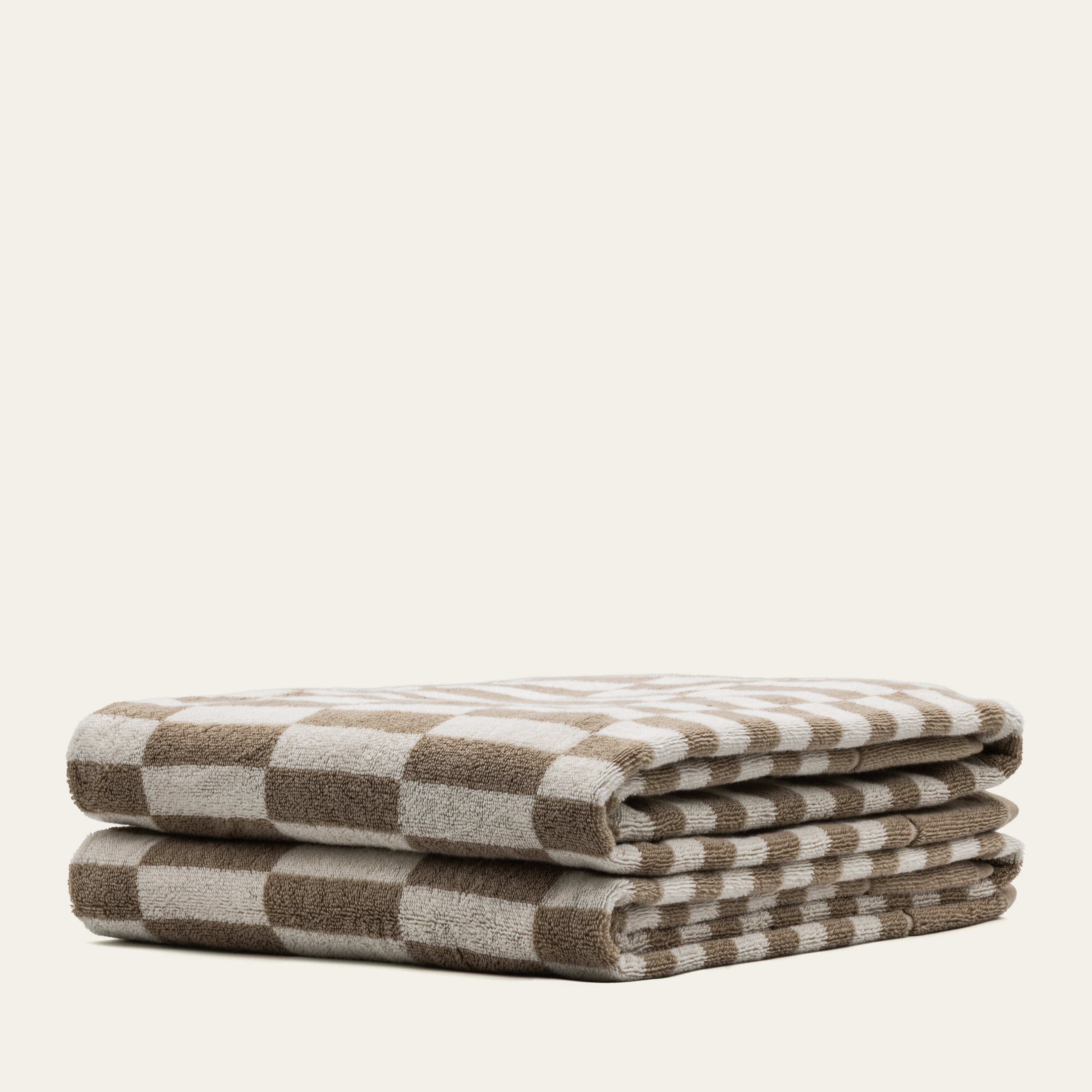 Thick Pietra Australian Cotton Bathsheet from Italic, showcasing soft, plush white towels with textured weave, hanging on a towel rack.