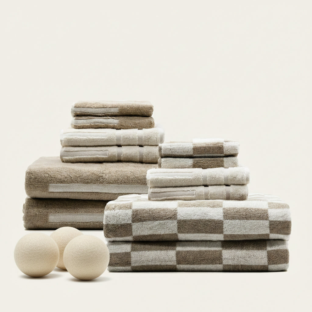 Set of Pietra Australian cotton towels from Italic, displayed in a family-sized bundle with rolled and folded towels.