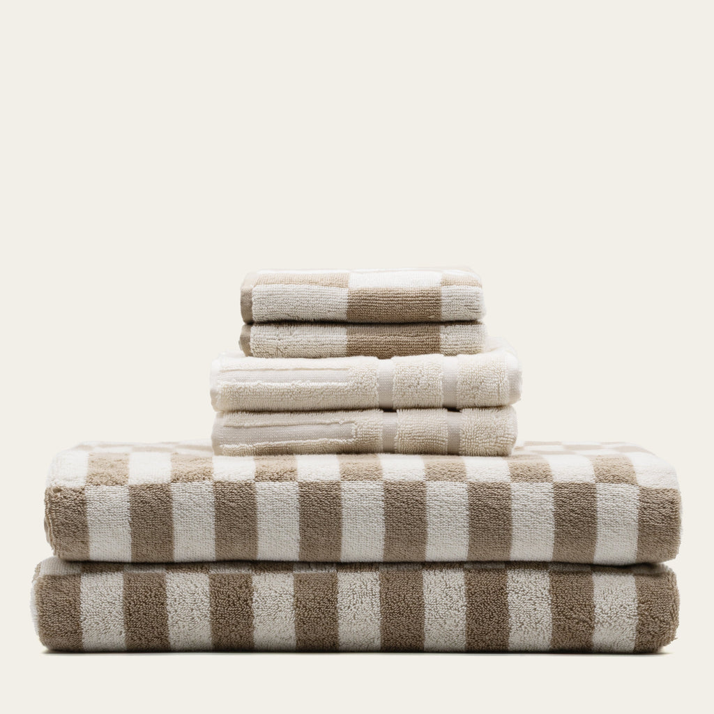 Luxurious Pietra Australian Cotton Towels by Italic, showing soft, plush white towels with a textured weave pattern.