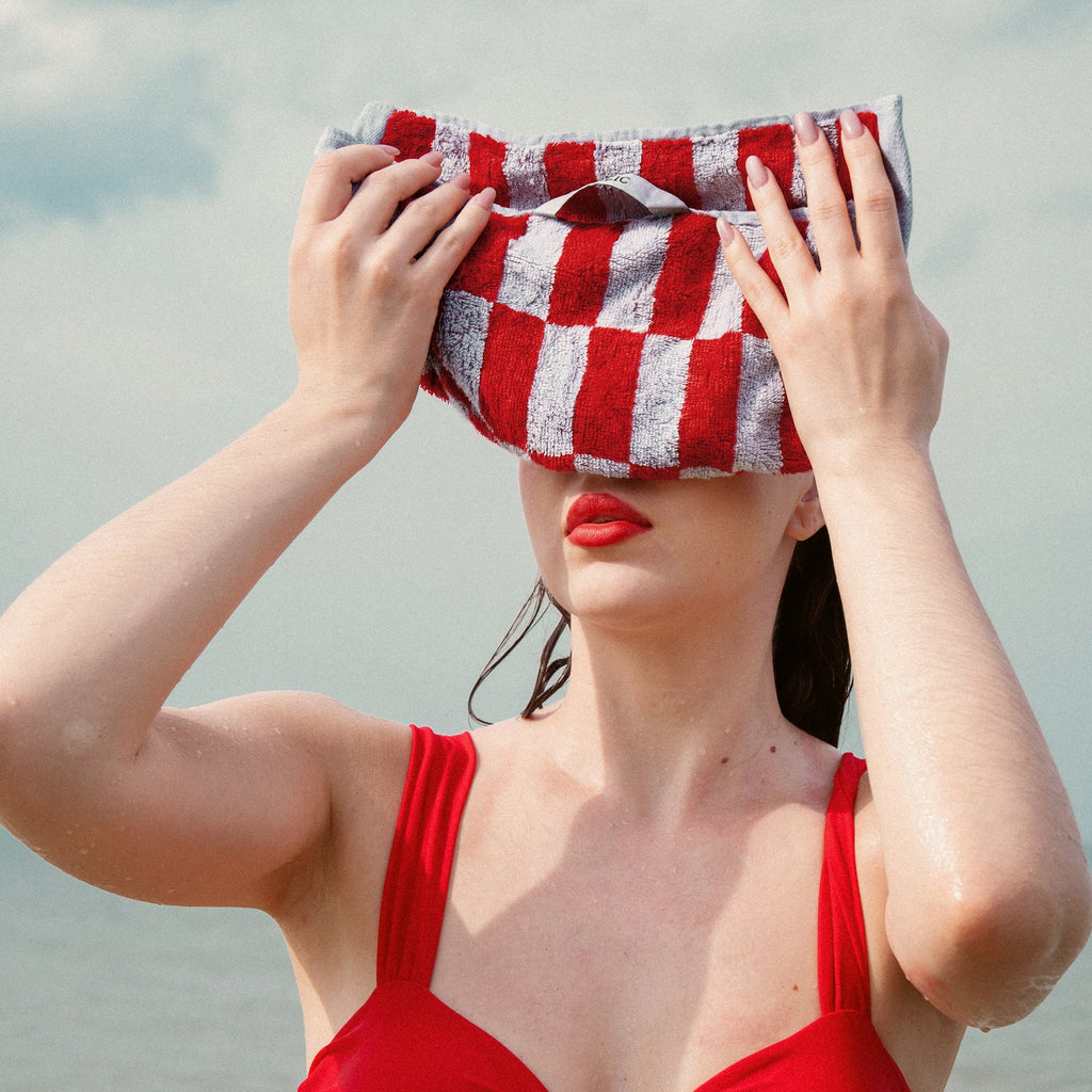 Italian-made Pietra Australian Cotton Towels in vibrant tomato color, featuring soft, plush texture and absorbent quality.