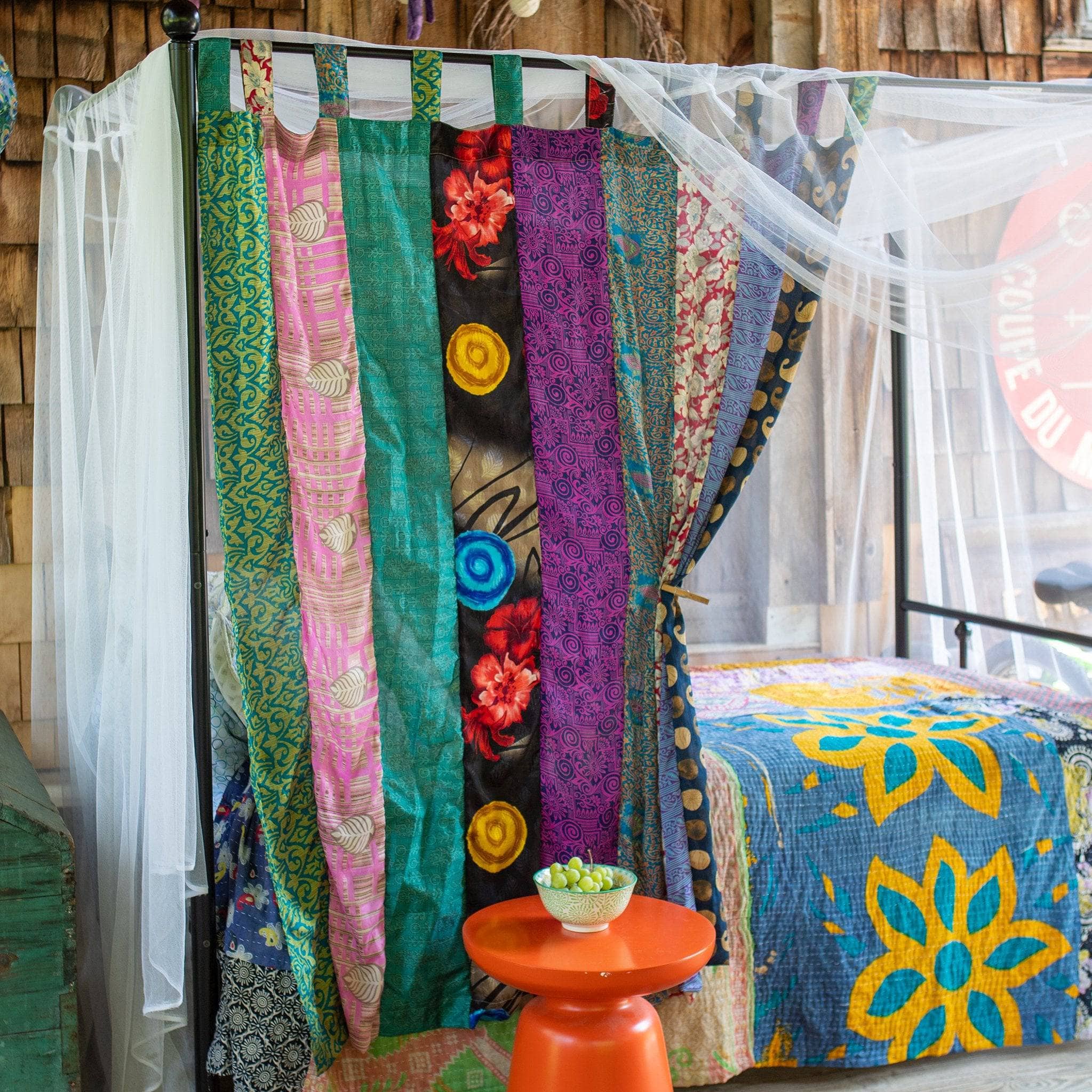 Colorful Rainbow Oasis upcycled sari curtains from Darn Good Yarn, featuring eco-friendly boho-inspired crochet and knit home decor.