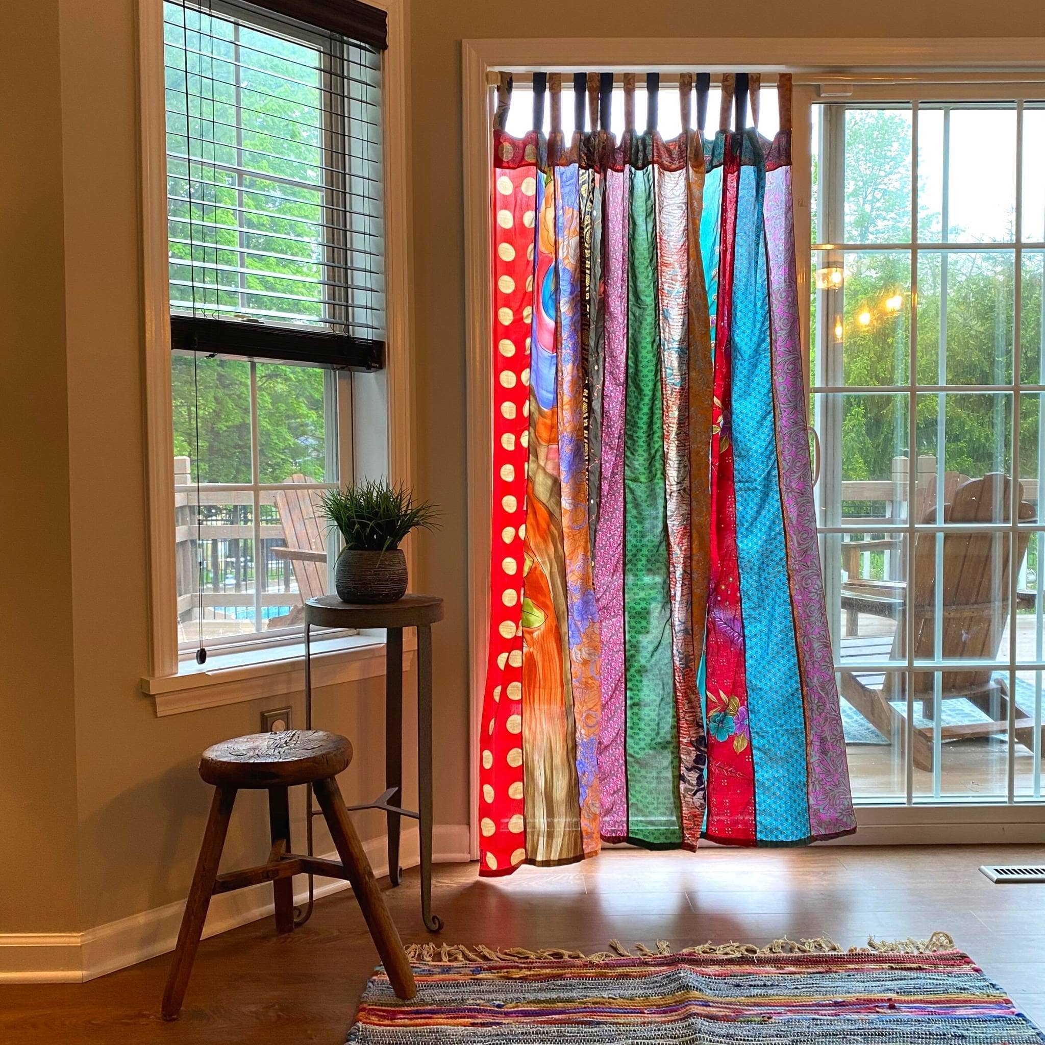 Colorful Rainbow Oasis upcycled sari curtains by Darn Good Yarn, eco-friendly boho home decor with vibrant crochet and knit details.