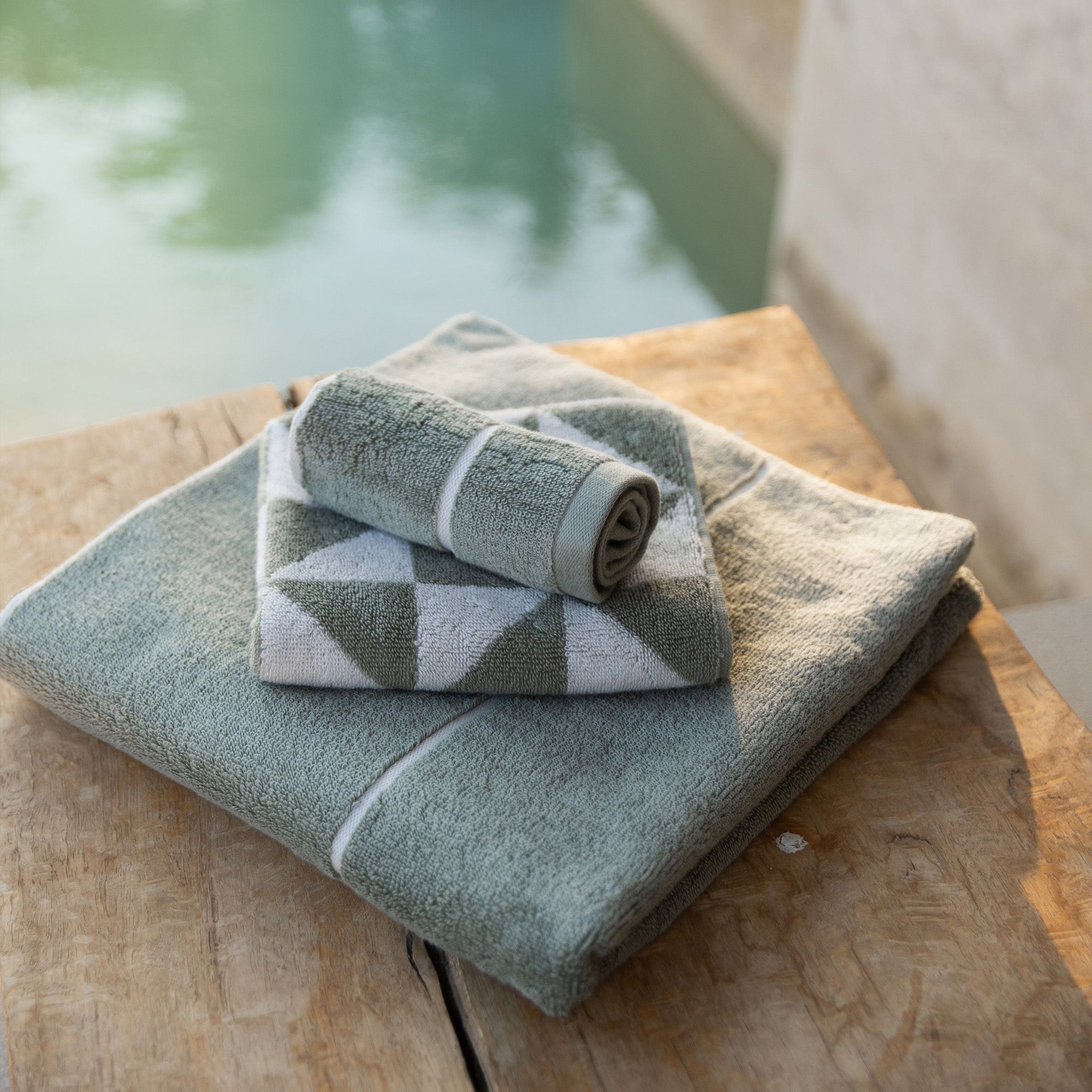 White Umbra Australian Cotton Bath Towels by Italic, soft and plush, shown hanging on a towel rack in a modern bathroom setting.