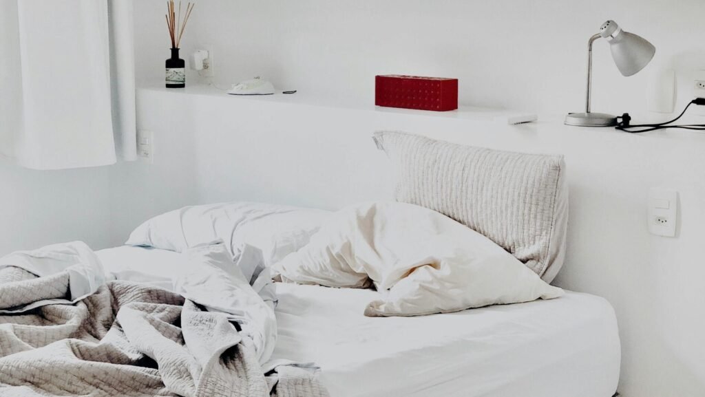 Contemporary bedroom design featuring art prints and cozy bedding for a warm ambiance.