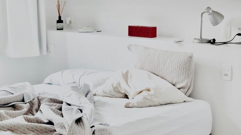 Contemporary bedroom design featuring art prints and cozy bedding for a warm ambiance.