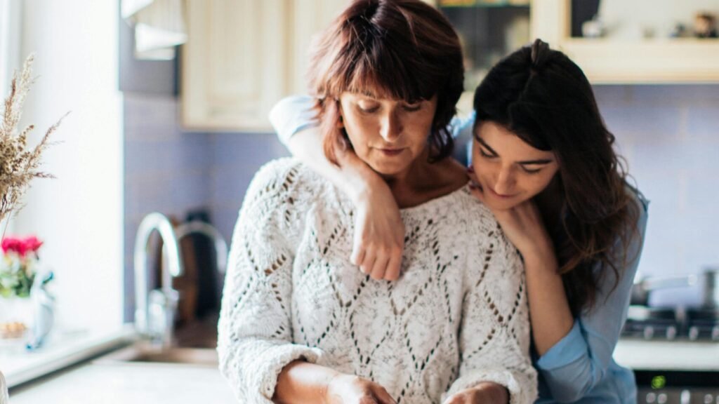 A mother and daughter bond while preparing traditional dumplings in a cozy kitchen setting.